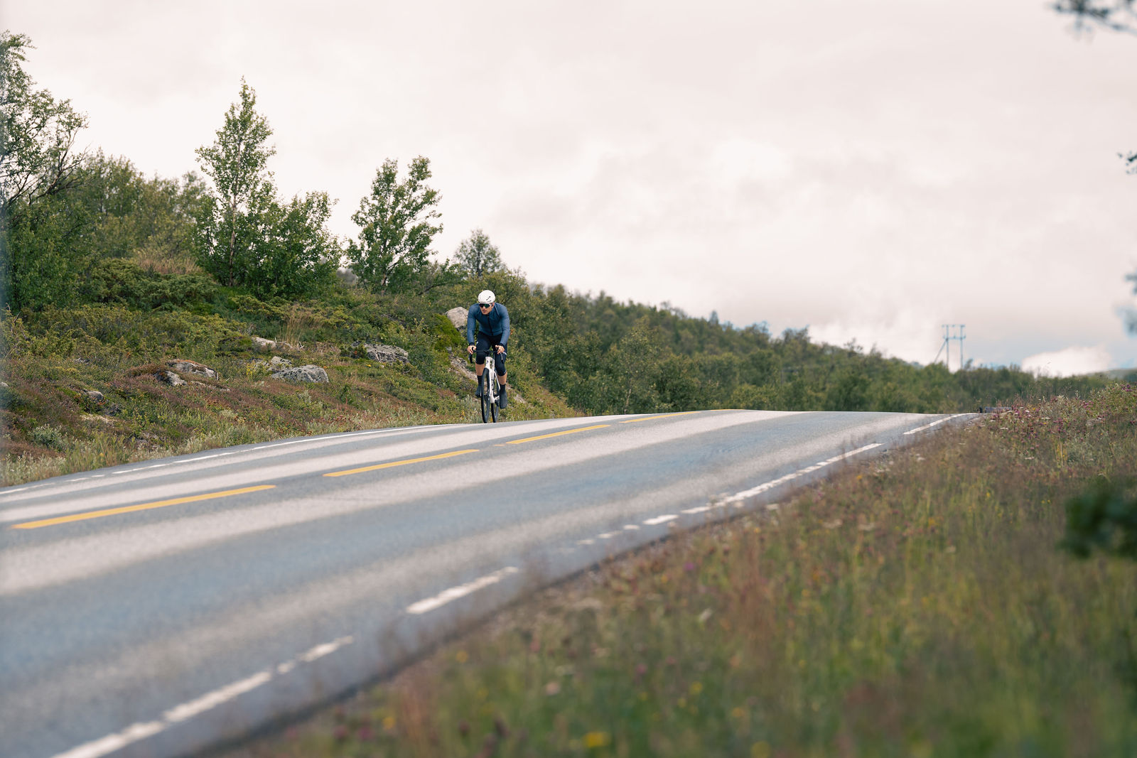 Kristian Grue riding on an open mountain road during Norseman